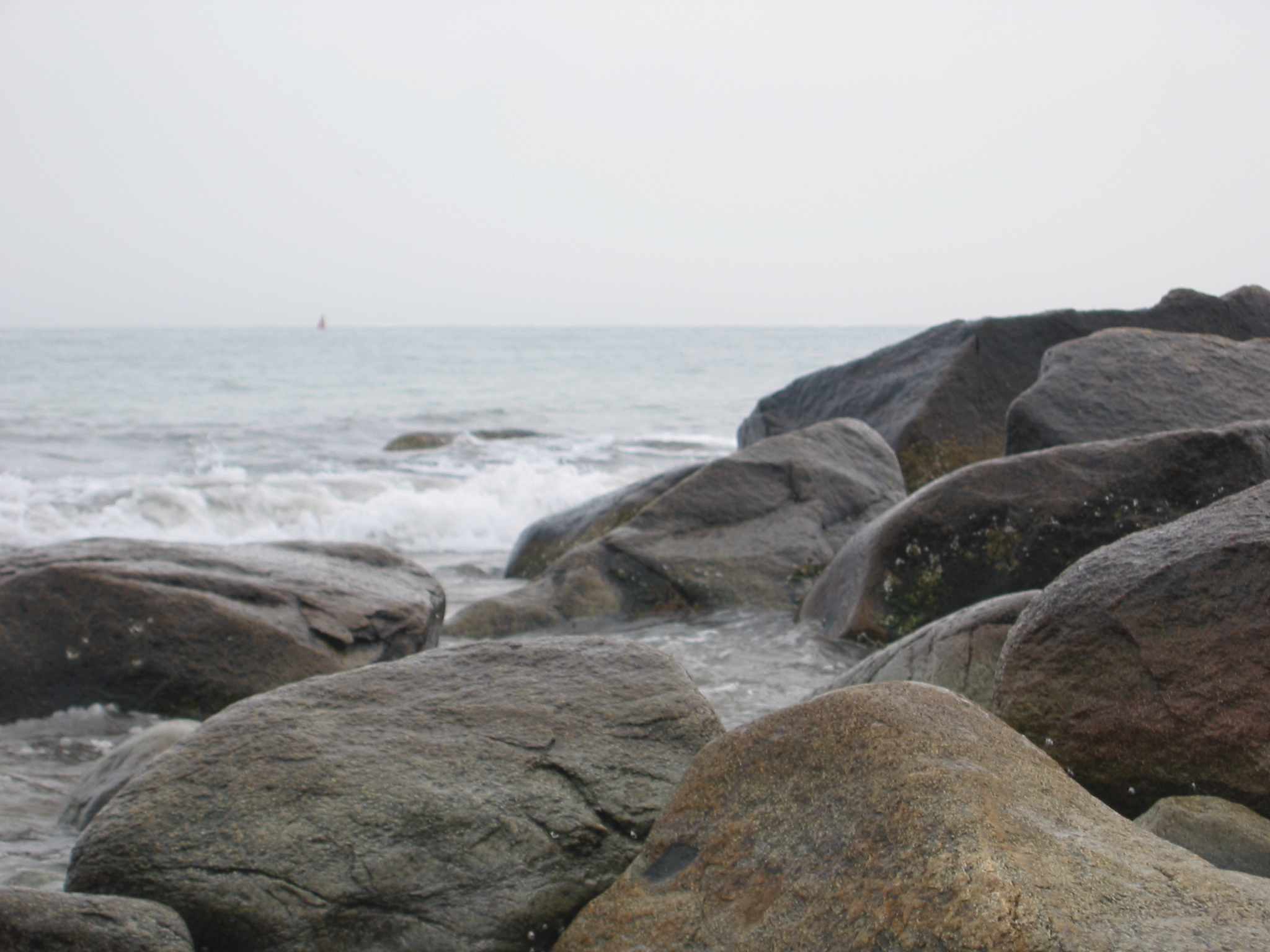 image of the ocean waves hitting slick rocks