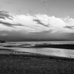 dramatic black and white photo of a beach and ocean